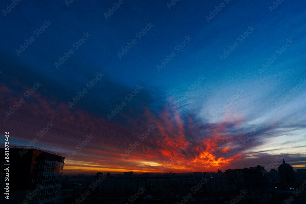 Fototapeta premium evening sky over the city, scarlet clouds in the setting sun, red sunset over the city