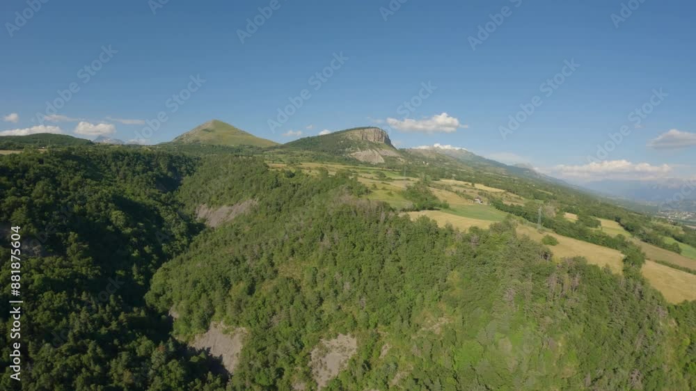 FPV drone aerial view of rural countryside and mountains, agricultural fields and landscapes, filmed on a summer evening at sunset. Idyllic scenery for nature and rural projects. FPV drone aerial view of rural countryside and mountains, agricultural fields and landscapes, filmed on a summer evening at sunset. Idyllic scenery for nature and rural projects.