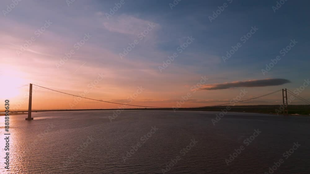 Aerial drone takes you to the Humber Bridge at sunset, where cars become part of a breathtaking masterpiece Aerial drone takes you to the Humber Bridge at sunset, where cars become part of a breathtaking masterpiece