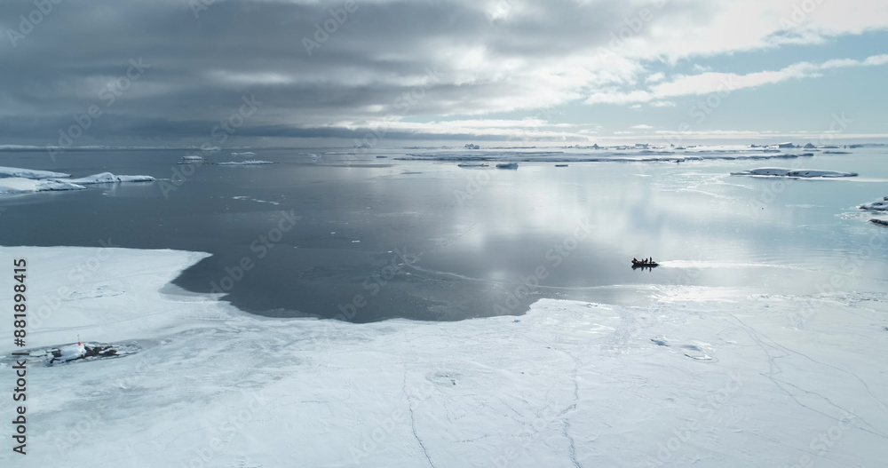 Obraz premium People travel Antarctica shore ride zodiac boat. Frozen polar ocean ice coast. Arctic snow covered landscape. Explore South Pole wild winter nature. Tourism, travel, expedition. Aerial drone panorama