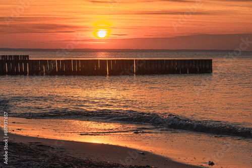 Obraz na płótnie View of sand beach with wooden breakwaters on the Baltic Sea coast on sunset in Zelenogradsk. Russia w salonie