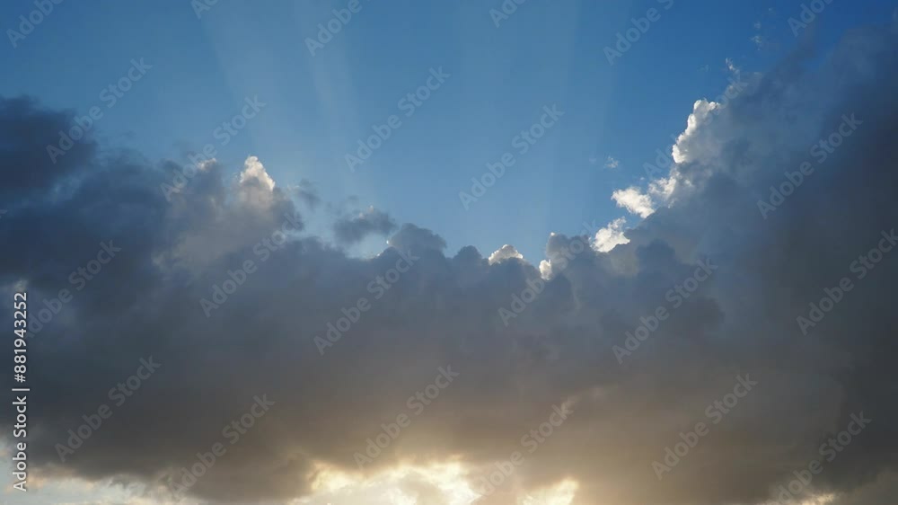 Beautiful clouds in sky. Volumetric light cumulus effect. The sunrays are hidden behind dark clouds. Convection in troposphere. Movement of moisture in atmosphere. Weather forecast