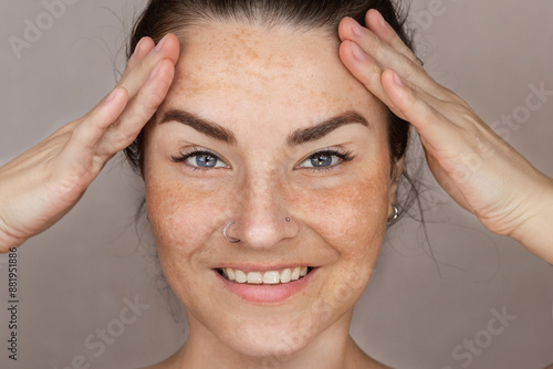 Caucasian woman's face with freckles or age spots photo