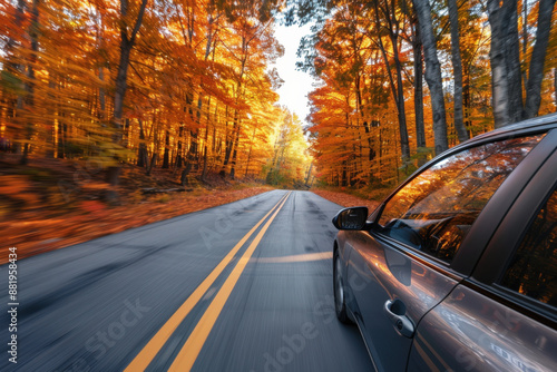 Car speeds down a colorful autumn road, sunlight filtering through the trees, creating a serene scene. The journey evokes freedom and wanderlust, perfect for a scenic fall drive photo