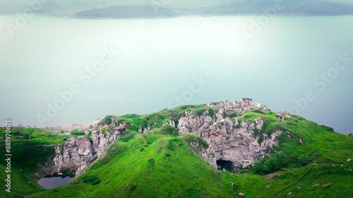 On the shores of Lake Mont Cenis between France and Italy, 4K drone video before sunset, green valley with a foggy atmosphere