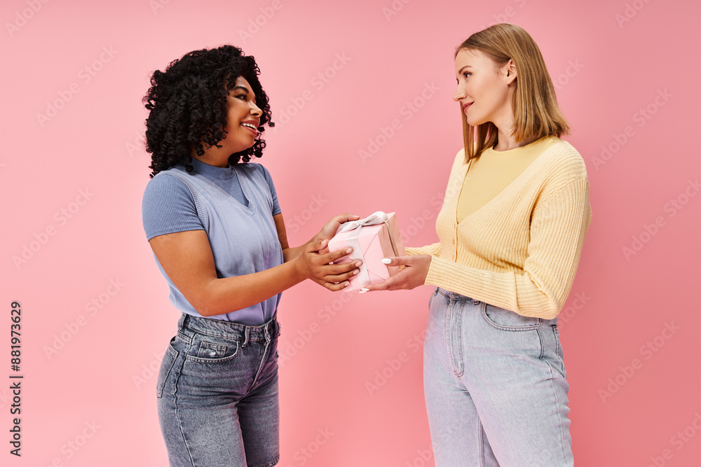 Two diverse women in casual attire standing together, exchanging a present with smiles. Two diverse women in casual attire standing together, exchanging a present with smiles.