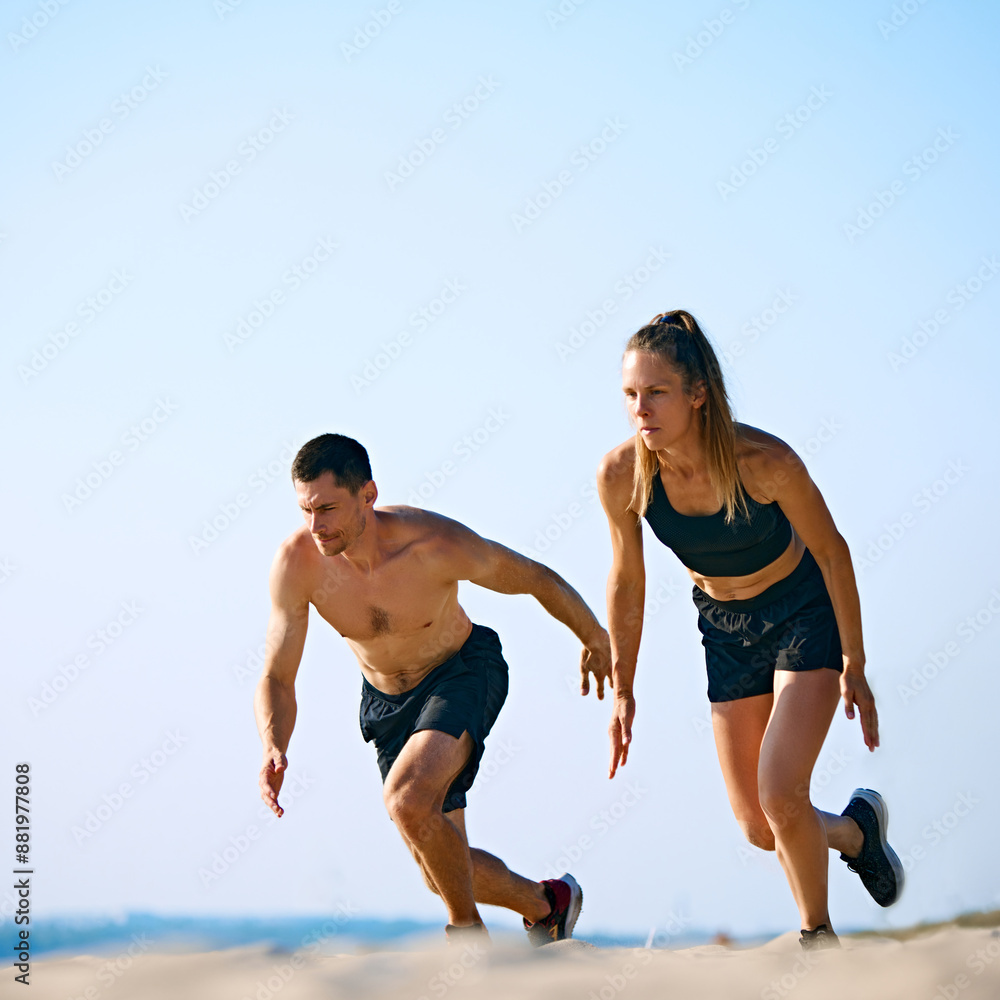 Dynamic and hard training outdoor session. Sportive young man and woman training on sandy beach, running under clear sky. Concept of sport, active and healthy lifestyle, body care, fitness Dynamic and hard training outdoor session. Sportive young man and woman training on sandy beach, running under clear sky. Concept of sport, active and healthy lifestyle, body care, fitness