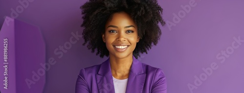Smiling Woman With Curly Hair Posing Against Purple Background