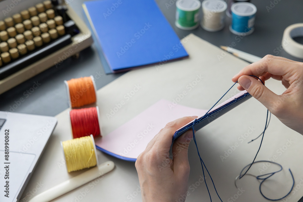 Ταπετσαρία High-quality image of a person binding a book using traditional coptic stitch technique