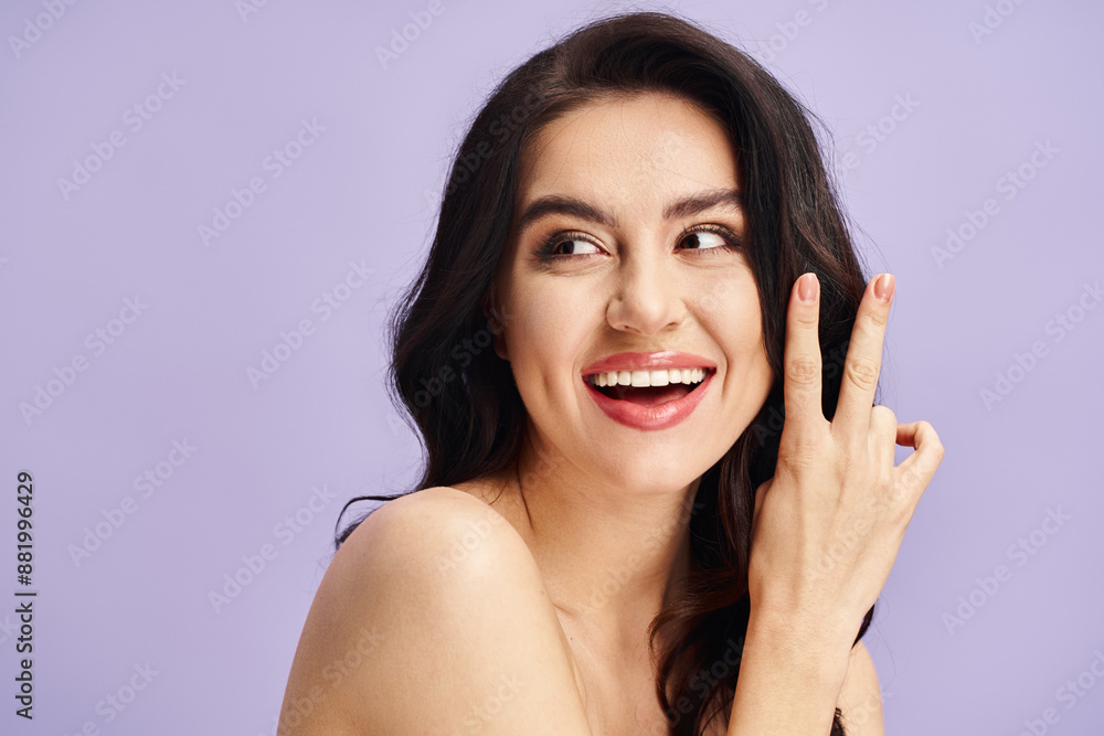 A woman with a bright smile and makeup, holding hand to face. A woman with a bright smile and makeup, holding hand to face.