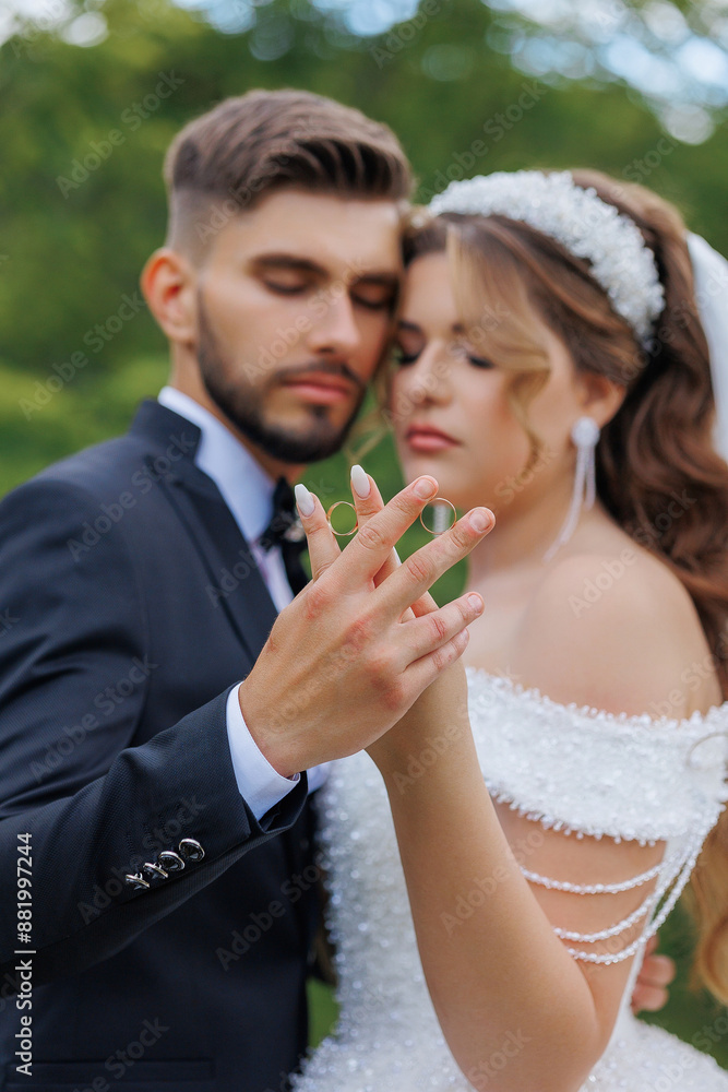 A man and woman are embracing each other, with the man holding the woman's hand. The man is wearing a suit and tie, and the woman is wearing a wedding dress. Concept of love and commitment A man and woman are embracing each other, with the man holding the woman's hand. The man is wearing a suit and tie, and the woman is wearing a wedding dress. Concept of love and commitment