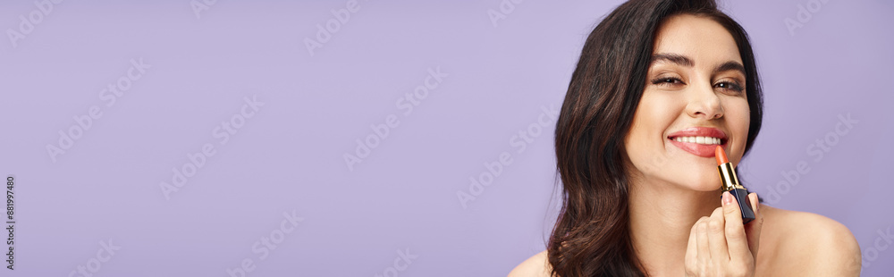 A woman enhancing her natural beauty by carefully applying lipstick to her lips. A woman enhancing her natural beauty by carefully applying lipstick to her lips.