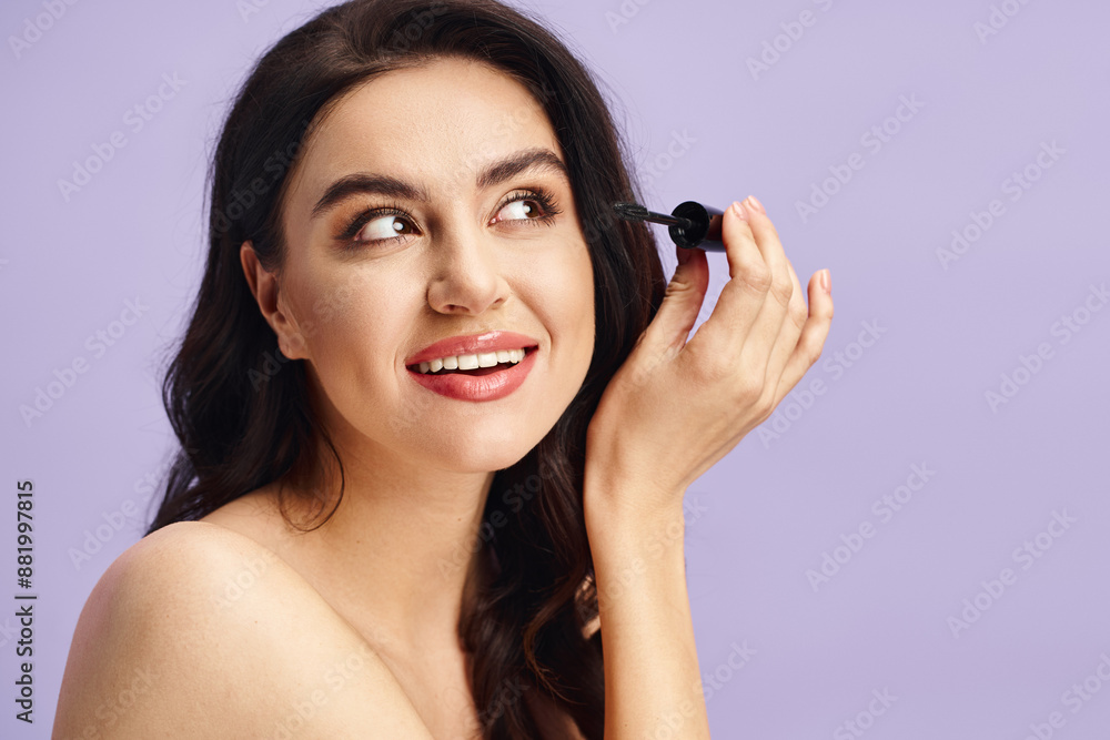 A woman with natural beauty holds a mascara in her hand. A woman with natural beauty holds a mascara in her hand.