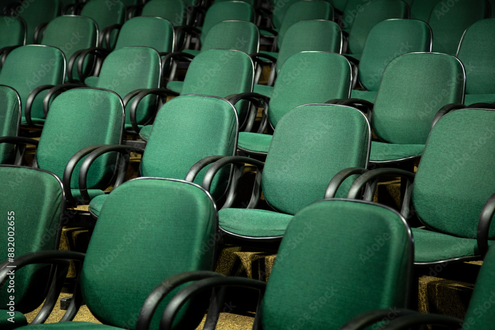Fototapeta premium Algumas fileiras de cadeiras verdes em um auditório.