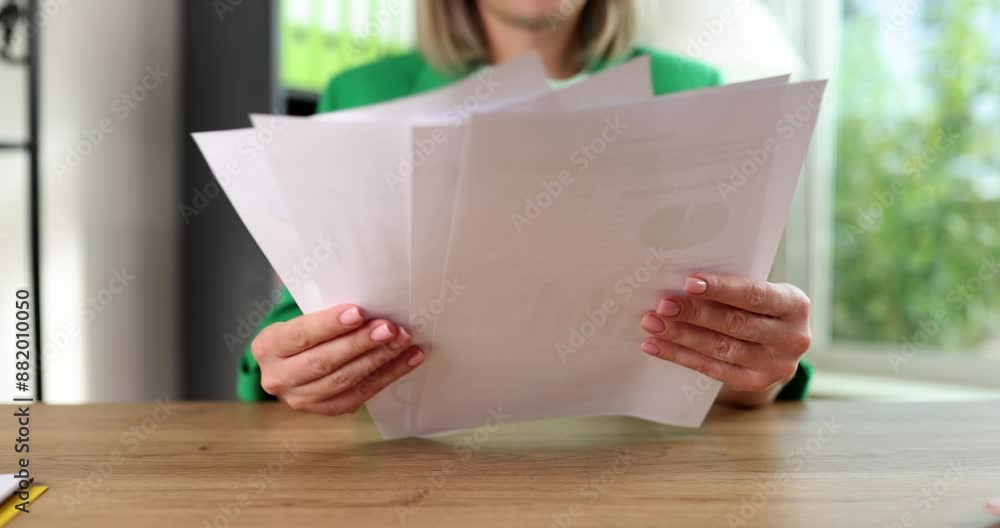 Woman accountant marketer studies financial report. Studying analytics and statistics Woman accountant marketer studies financial report. Studying analytics and statistics