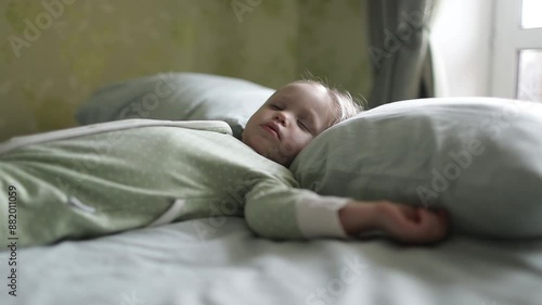 A small child is sleeping in a bed. Deep sleep. Close-up.