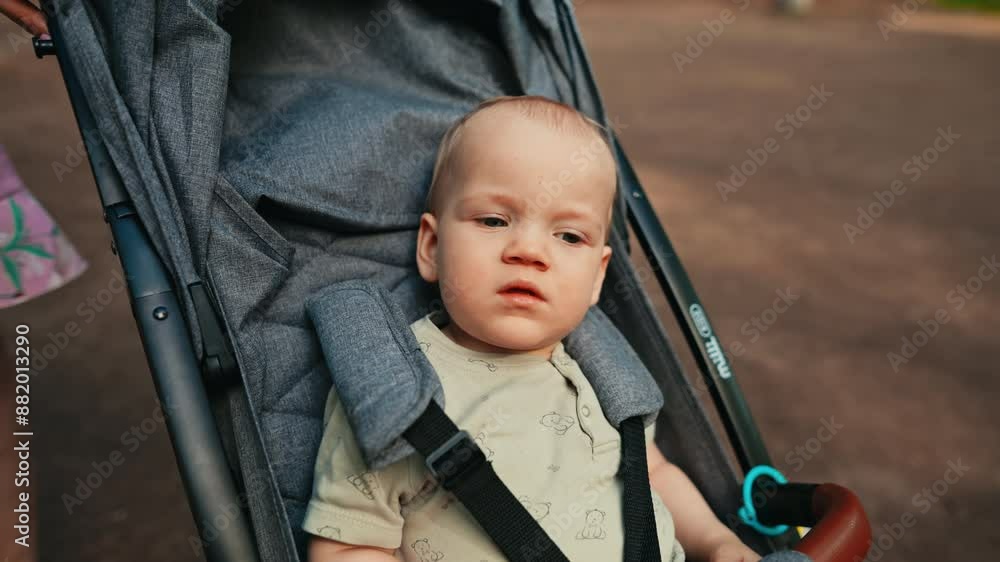 A baby enjoys a carefree stroll in a stroller with their family, bonding and exploring in the park on a sunny day A baby enjoys a carefree stroll in a stroller with their family, bonding and exploring in the park on a sunny day