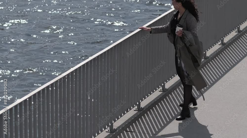 Embracing the morning light, she enjoys a solitary walk on the bridge, the peaceful waters providing a perfect backdrop for contemplation and renewal. Embracing the morning light, she enjoys a solitary walk on the bridge, the peaceful waters providing a perfect backdrop for contemplation and renewal.