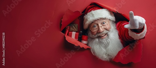 Happy Santa Claus Giving Thumbs Up Through Red Wrapping Paper