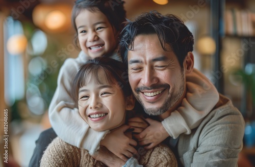 Happy Family Portrait With Father and Two Daughters Inside a Cafe