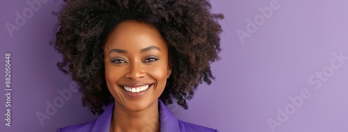 Smiling Woman With Curly Hair Against Purple Background
