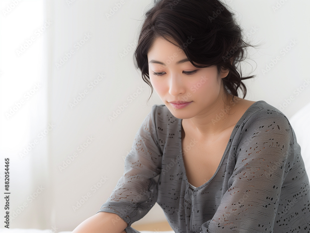 ソファに座って俯く女性