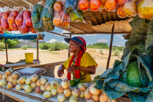 Fotografie african woman vegetable street vendor, self employed working at her street stall