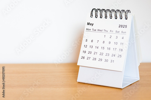 2025 calendar - May month page on the wooden desk