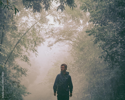 homem caminhando em estrada com neblina em Guaramiranga, Ceará  photo