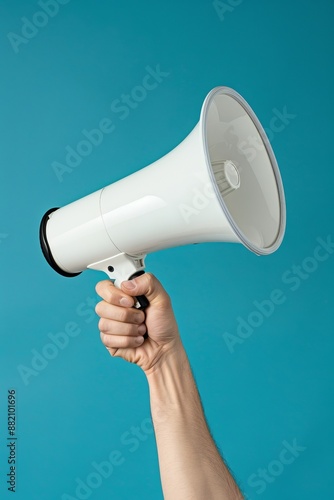 Photograph of a hand with a mouthpiece on an empty blue background