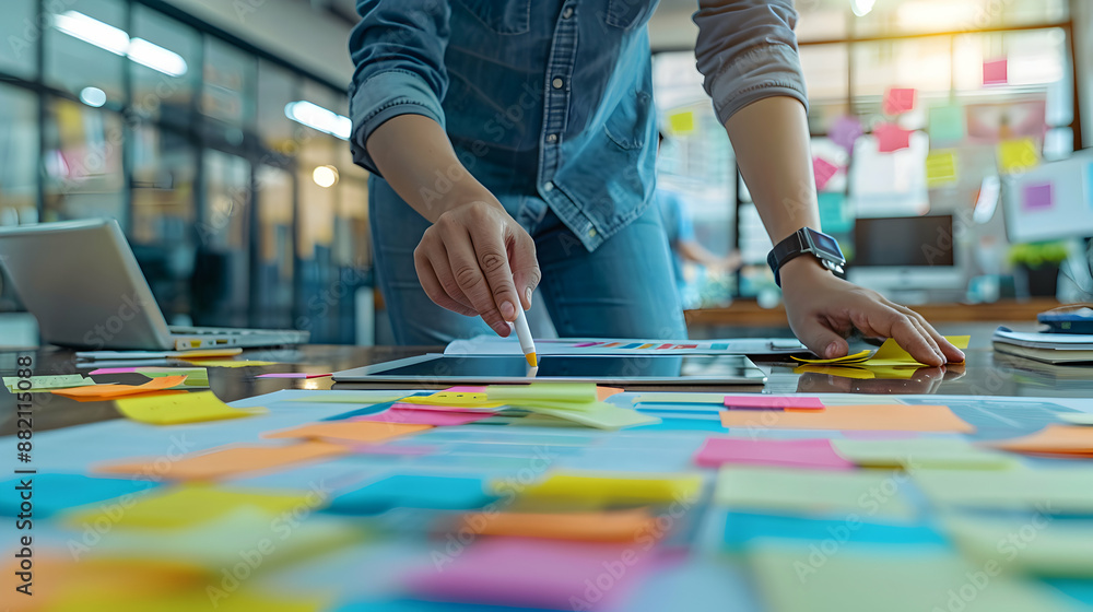 Obraz premium Team Collaboration Concept: Person Working on Project with Sticky Notes and Tablet Exciting Teamwork and Creativity Symbolized with Copy Space for Writing on Photo Stock.