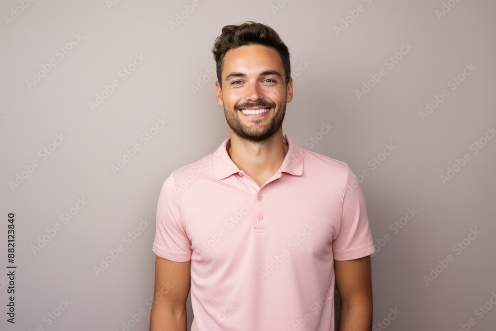 Portrait of a joyful man in his 30s donning a classy polo shirt in front of light wood minimalistic setup Portrait of a joyful man in his 30s donning a classy polo shirt in front of light wood minimalistic setup