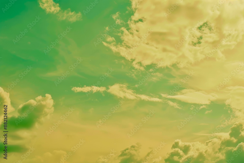 Fototapeta premium Vibrant Green and Yellow Sky With Fluffy Clouds on a Sunny Day