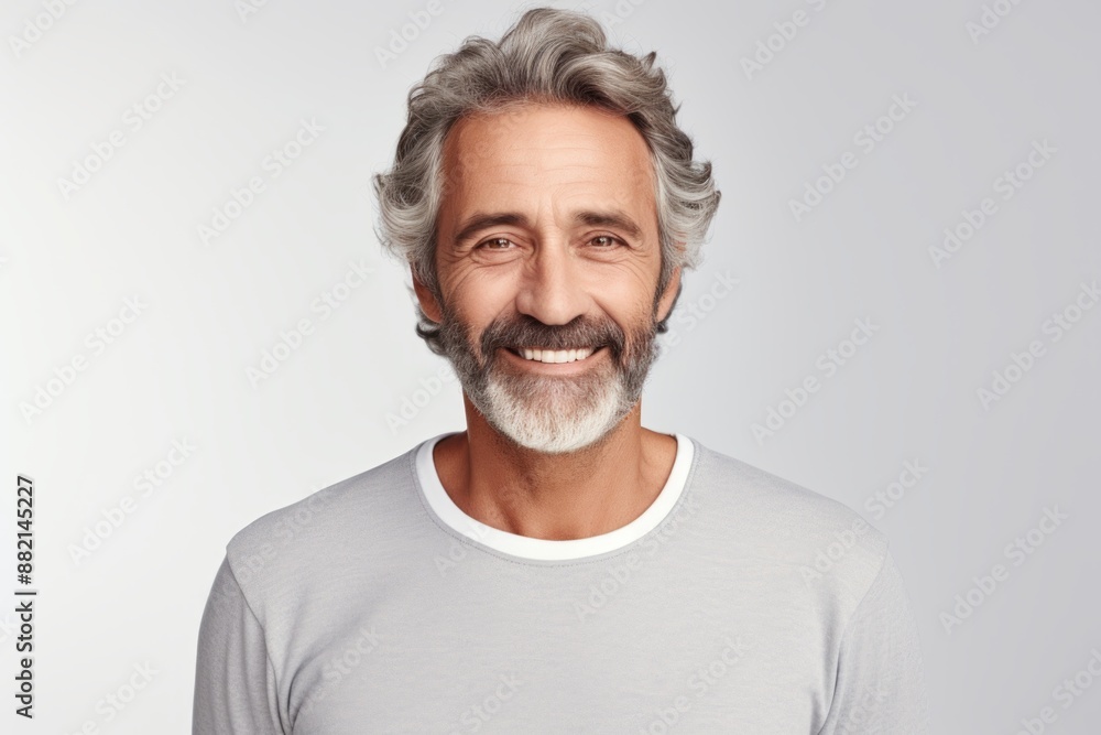Portrait of a grinning man in his 60s showing off a thermal merino wool top on plain white digital canvas Portrait of a grinning man in his 60s showing off a thermal merino wool top on plain white digital canvas