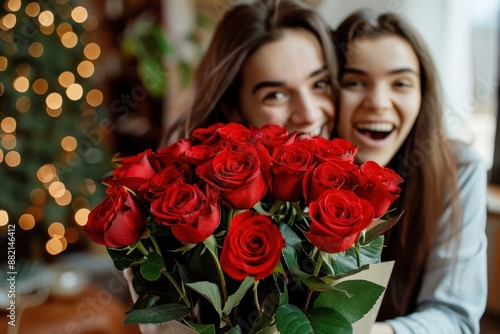 Man giving his amazed girlfriend bunch of red roses on Valentine's Day