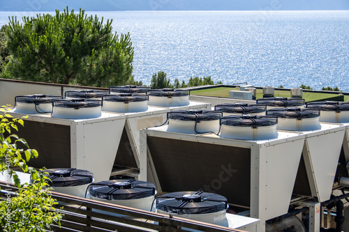 Schilderij op canvas Commercial HVAC Systems Overlooking Serene Sea, Industrial Air Conditioners on B