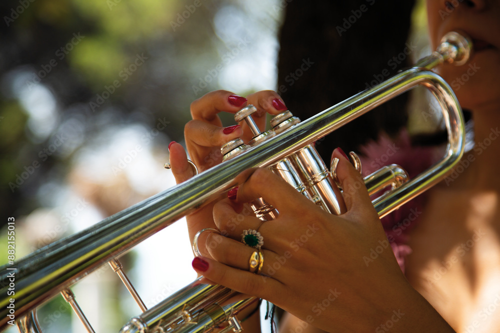 Fototapeta premium person playing the trumpet. Dettaglio mani di donna che suonano tromba