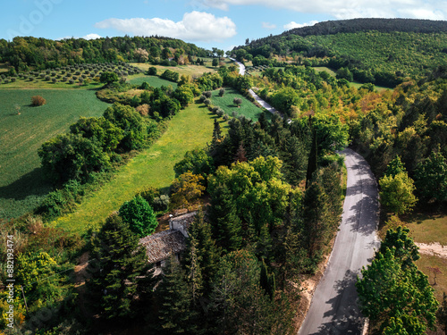 Aerial View of a White Farmhouse in a Wooded Area