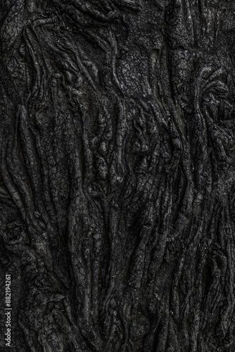 Black volcanic rock forming abstract natural pattern photo