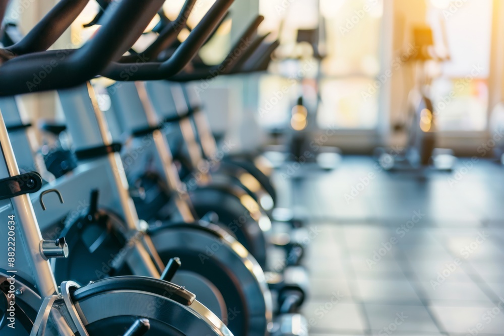 Fototapeta premium Row of exercise bikes in a gym. Fitness and workout equipment concept.