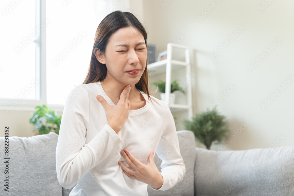 Acid reflux disease, suffer asian young woman have symptom gastroesophageal, esophageal, stomach ache and heartburn pain hand on chest from digestion problem after eat food, Healthcare medical concept Acid reflux disease, suffer asian young woman have symptom gastroesophageal, esophageal, stomach ache and heartburn pain hand on chest from digestion problem after eat food, Healthcare medical concept