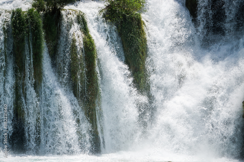 Fototapeta premium Waterfall among the green summer forest.
