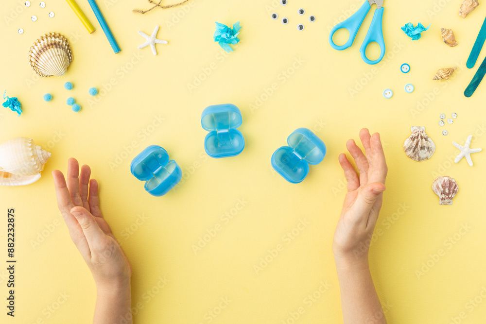 Adorable jellyfish made from plastic blue egg, Kids craft at home or kindergarten. Hands making DIY summer crafting with children. Ocean's day. Adorable jellyfish made from plastic blue egg, Kids craft at home or kindergarten. Hands making DIY summer crafting with children. Ocean's day.