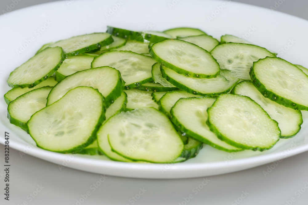 Cucumbers cut into circles on dish, side view close-up Cucumbers cut into circles on dish, side view close-up