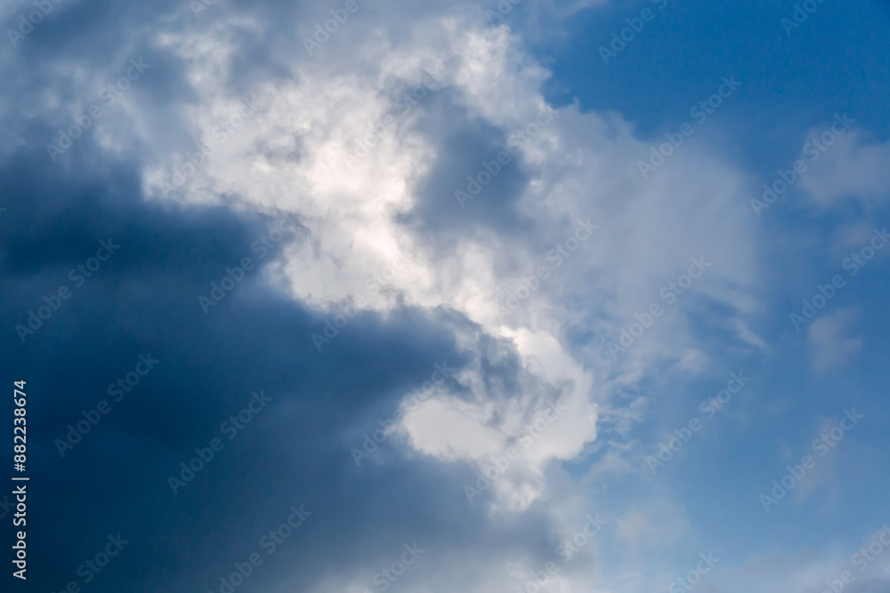 Part of sky with storm cloud edge against blue sky Part of sky with storm cloud edge against blue sky