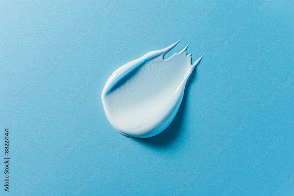 Texture swatch of blue cream on the blue background. Copy space for text. Concept: advertising beauty photo, skin care product, cosmetic product Texture swatch of blue cream on the blue background. Copy space for text. Concept: advertising beauty photo, skin care product, cosmetic product