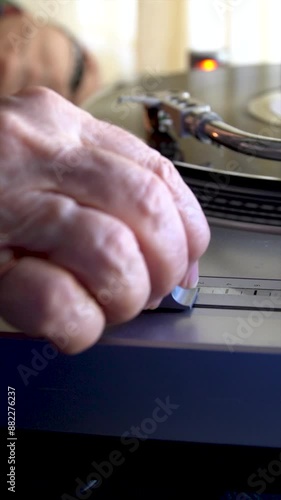 Slow motion, close-up of a person moving the pitch slider on the turntable photo