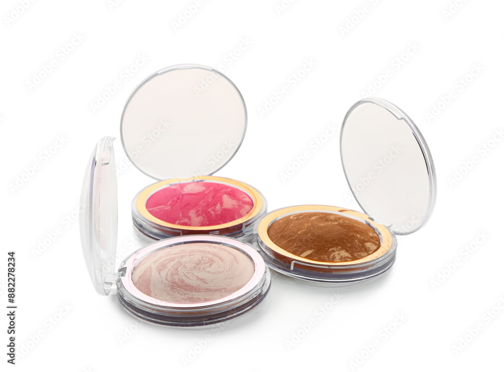 Stylish blush, powder and highlighter on white background Stylish blush, powder and highlighter on white background