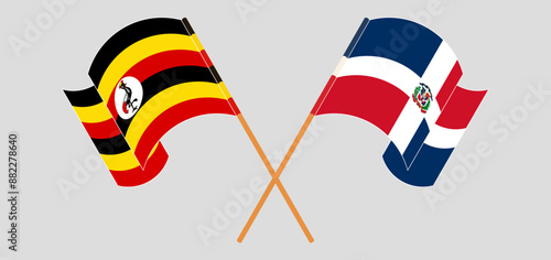 Crossed and waving flags of Uganda and Dominican Republic. Vector illustration
