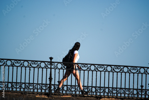 Wallpaper Mural Girl crossing the popular Triana bridge Torontodigital.ca
